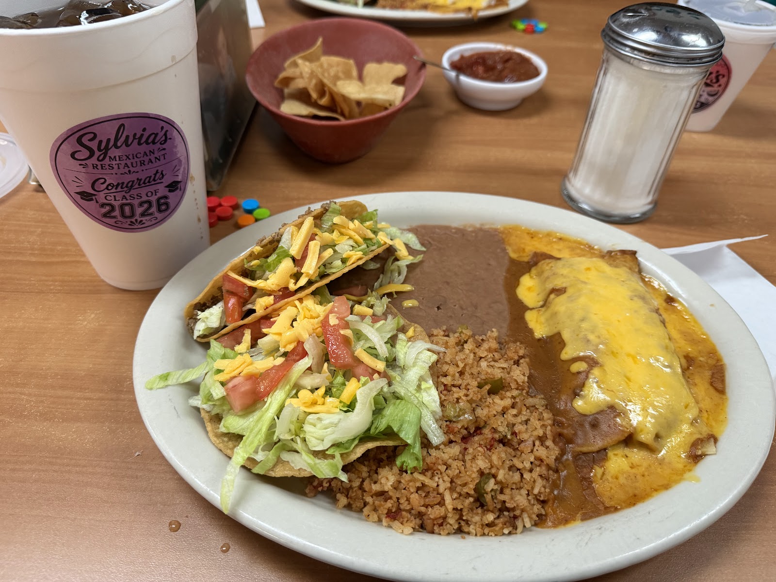 Crispy beef taco and cheese enchilada plate with rice, beans, chips and salsa at Sylvia's Mexican Restaurant