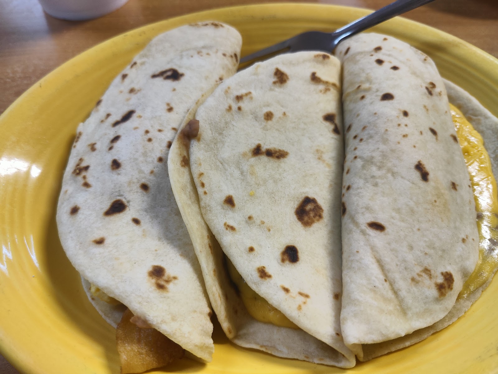 Three homemade breakfast tacos with egg, cheese and bacon at Sylvia's Mexican Restaurant